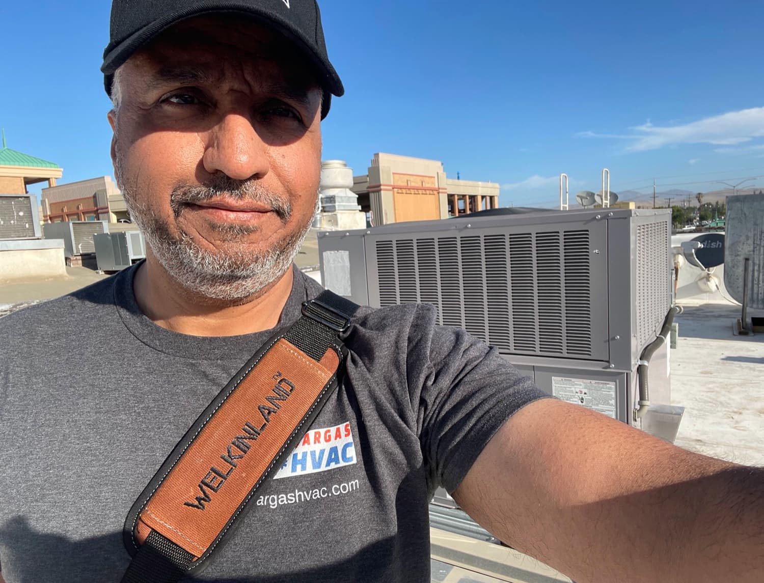 Vargas HVAC co-founder at a commercial rooftop package unit